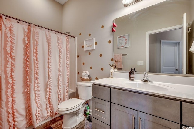 bathroom featuring vanity, shower / tub combo, toilet, and wood finished floors