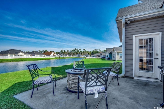 view of patio featuring a residential view, a water view, and an outdoor fire pit