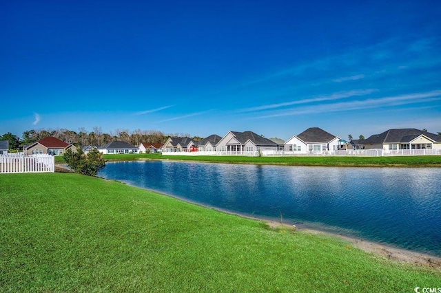 view of water feature with a residential view and fence