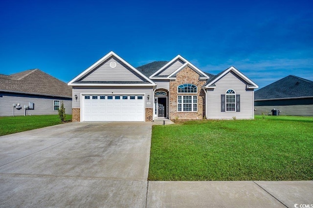 view of front facade featuring a garage, driveway, brick siding, and a front lawn