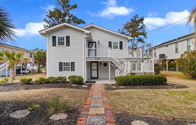 view of front of property with stairs and a front yard