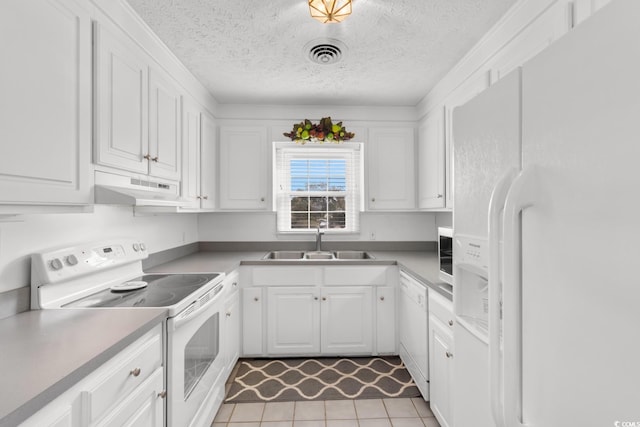 kitchen featuring white appliances, a sink, white cabinets, and under cabinet range hood