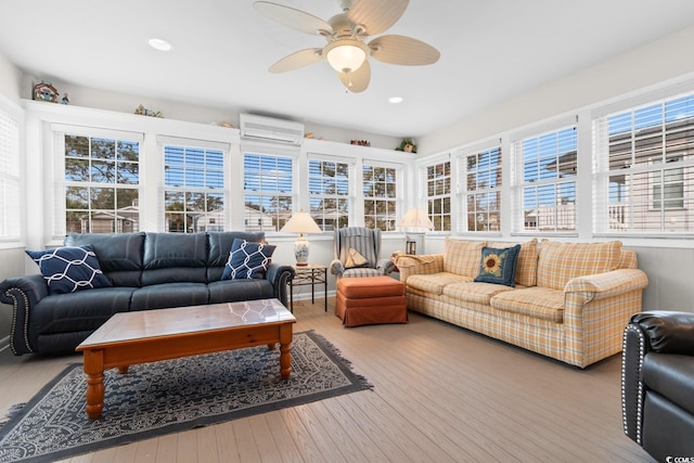 sunroom / solarium featuring a ceiling fan and an AC wall unit