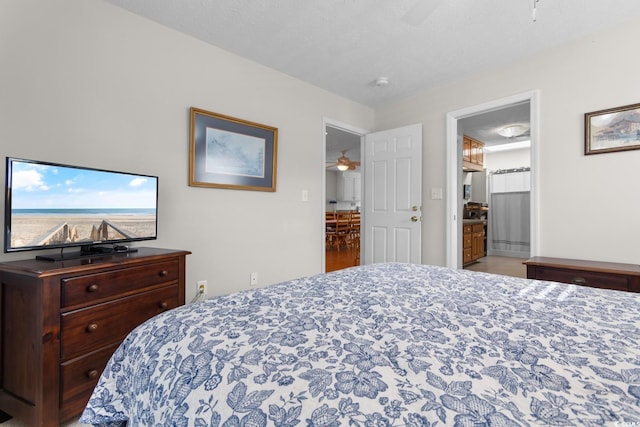 bedroom featuring connected bathroom and a textured ceiling