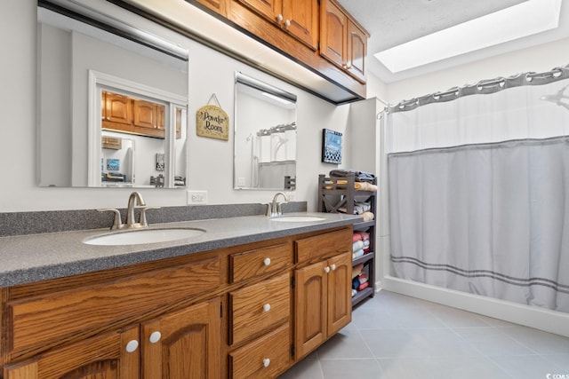 full bathroom featuring tile patterned floors, a sink, a shower with shower curtain, and double vanity