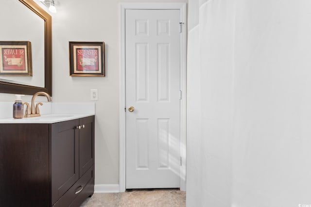 bathroom featuring vanity and baseboards