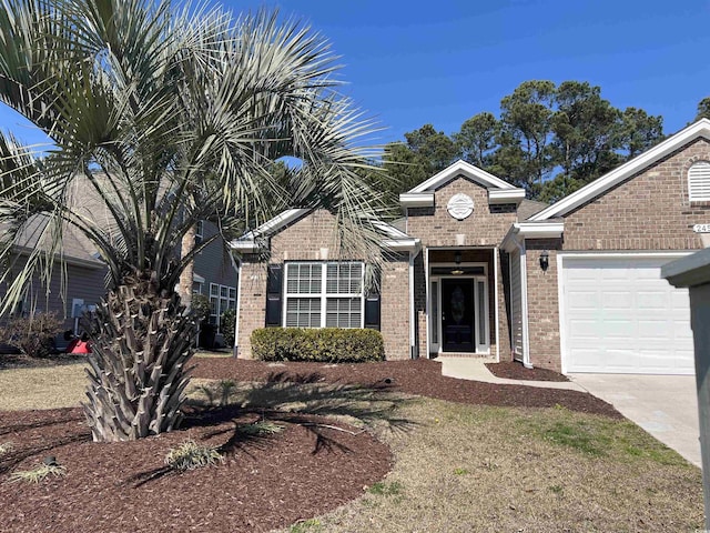 view of front of home with a garage, brick siding, and driveway