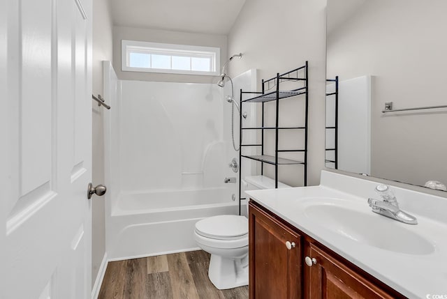 bathroom with shower / washtub combination, toilet, vanity, and wood finished floors