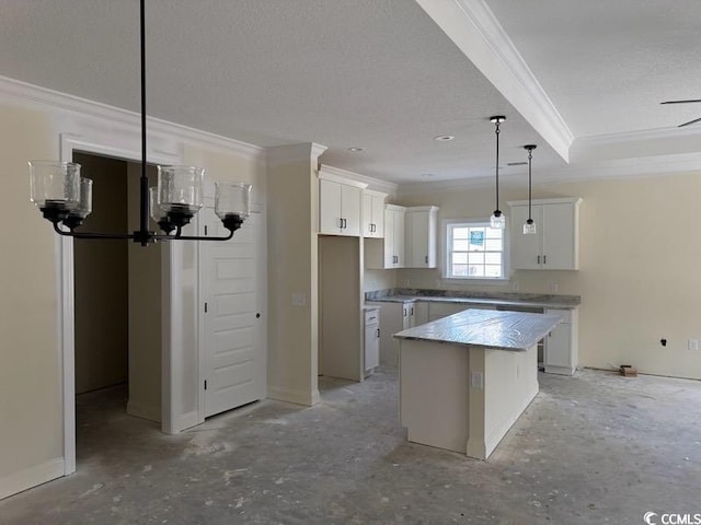 kitchen featuring a notable chandelier, ornamental molding, a center island, white cabinetry, and pendant lighting