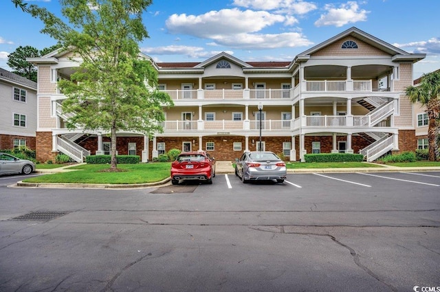 5750 Oyster Catcher Dr Unit 522, North Myrtle Beach, SC 29582 - view of property with stairs and uncovered parking