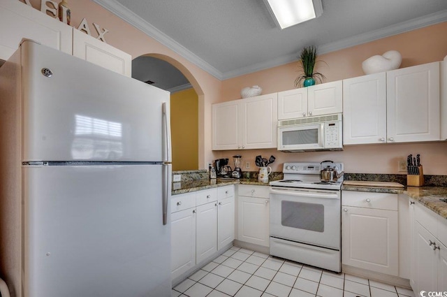 5750 Oyster Catcher Dr Unit 522, North Myrtle Beach, SC 29582 - kitchen with white appliances, crown molding, light tile patterned floors, white cabinets, and arched walkways
