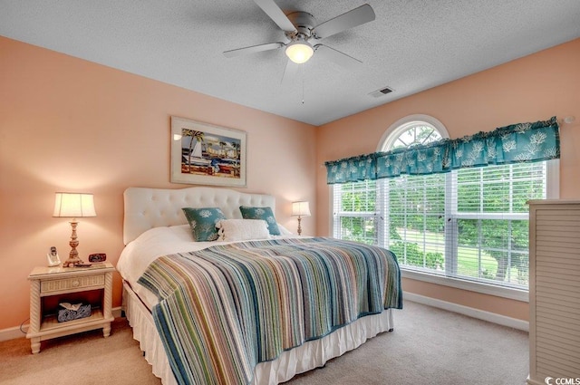 5750 Oyster Catcher Dr Unit 522, North Myrtle Beach, SC 29582 - bedroom featuring light carpet, a textured ceiling, and a ceiling fan