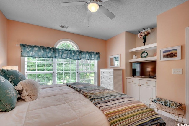 5750 Oyster Catcher Dr Unit 522, North Myrtle Beach, SC 29582 - bedroom with a textured ceiling and ceiling fan