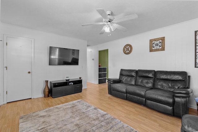 living area featuring a ceiling fan and wood finished floors