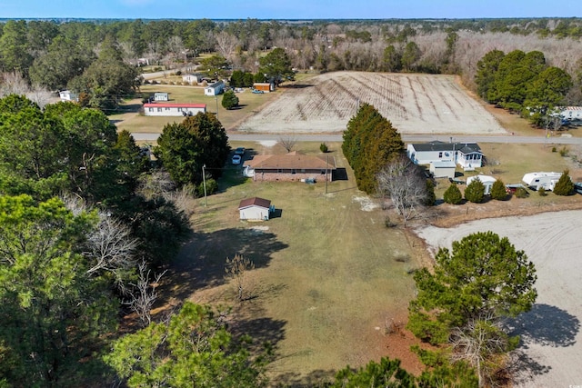 birds eye view of property with a view of trees