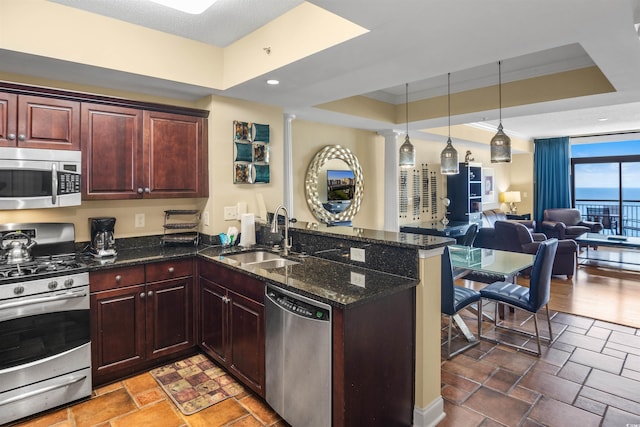100 N Beach Blvd Unit 1917, North Myrtle Beach, SC 29582 - kitchen with appliances with stainless steel finishes, a sink, a peninsula, a tray ceiling, and open floor plan