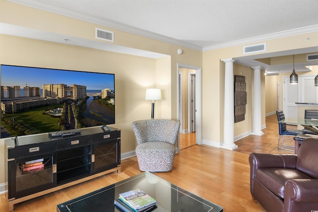 100 N Beach Blvd Unit 1917, North Myrtle Beach, SC 29582 - living area with decorative columns, ornamental molding, baseboards, wood finished floors, and a textured ceiling