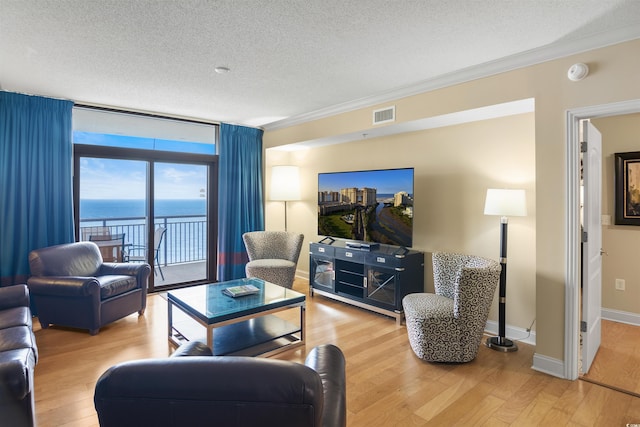 100 N Beach Blvd Unit 1917, North Myrtle Beach, SC 29582 - living area with a textured ceiling, wood finished floors, ornamental molding, and floor to ceiling windows