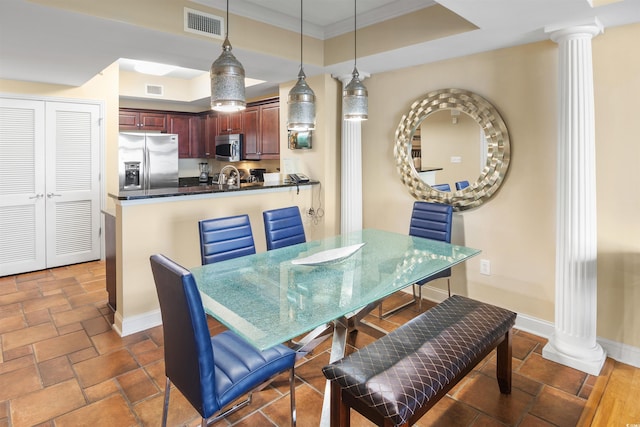 100 N Beach Blvd Unit 1917, North Myrtle Beach, SC 29582 - dining space with decorative columns, a tray ceiling, crown molding, baseboards, and dark stone finish floors