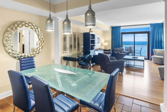 100 N Beach Blvd Unit 1917, North Myrtle Beach, SC 29582 - dining room featuring expansive windows, crown molding, a textured ceiling, baseboards, and wood finished floors