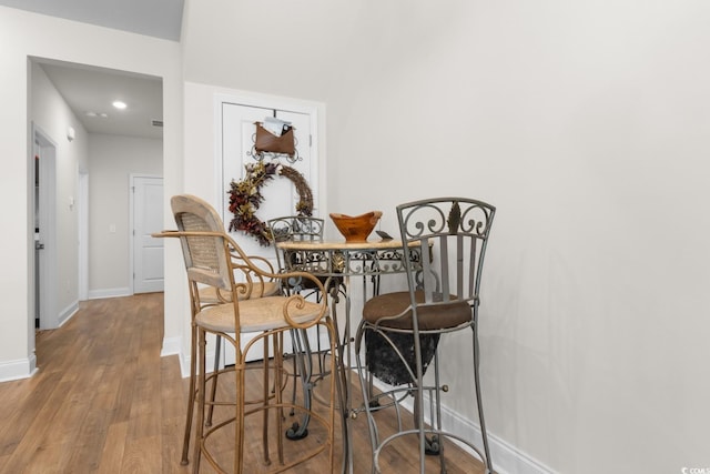 dining area featuring baseboards and wood finished floors