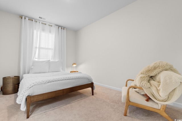 carpeted bedroom with baseboards and visible vents