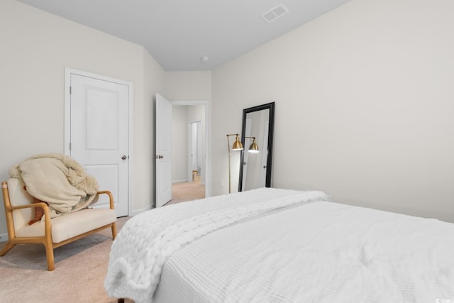 bedroom featuring baseboards, visible vents, and light colored carpet