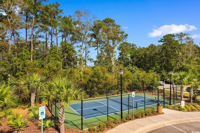 view of tennis court with fence