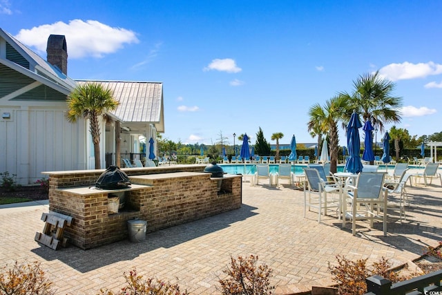 view of patio / terrace with a community pool and an outdoor bar