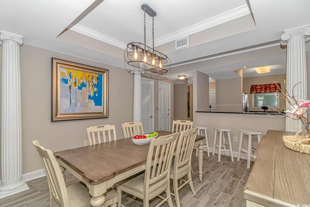 dining space with wood tiled floor, visible vents, and ornate columns