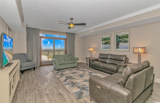 living room featuring light wood-style floors, baseboards, visible vents, and crown molding