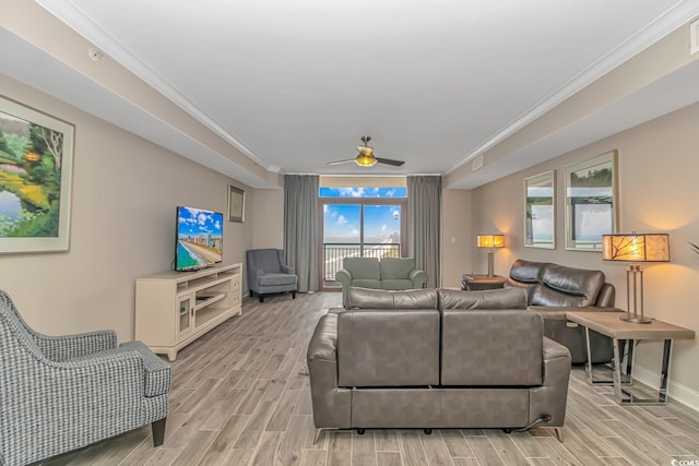 living room with ornamental molding, wood finish floors, visible vents, and baseboards