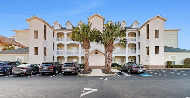 view of property featuring uncovered parking