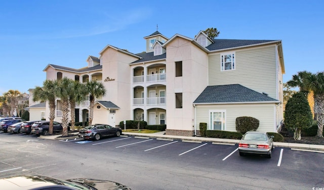 view of building exterior featuring uncovered parking