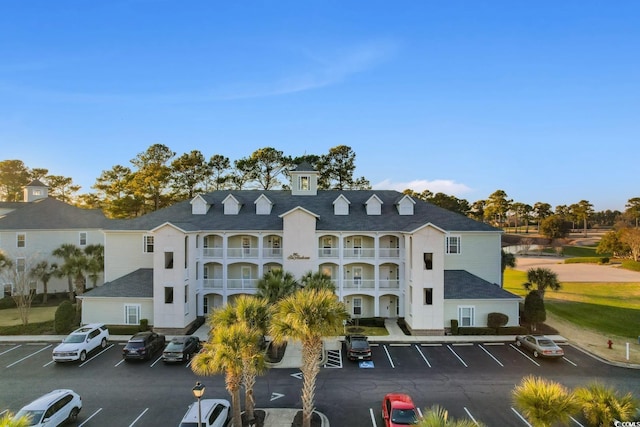 view of building exterior featuring uncovered parking