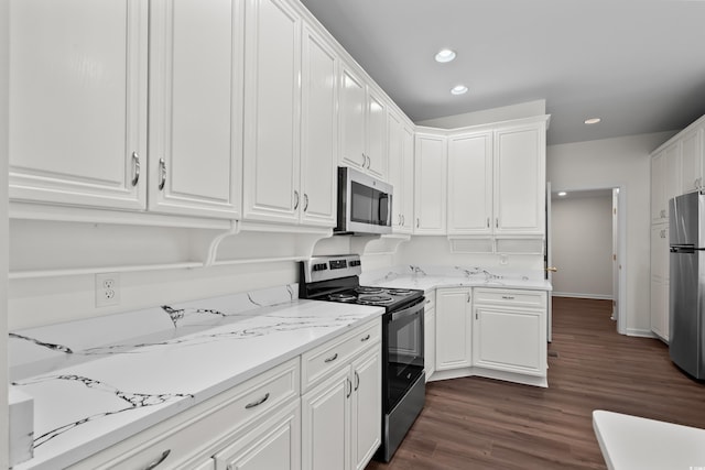 kitchen with light stone counters, dark wood-style flooring, stainless steel appliances, white cabinetry, and recessed lighting