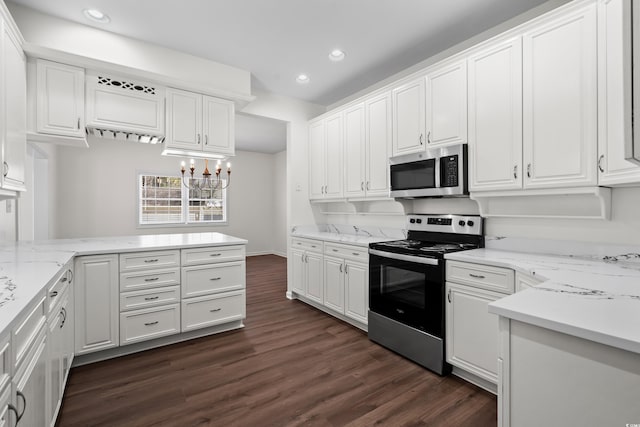 kitchen with dark wood-style floors, an inviting chandelier, stainless steel appliances, white cabinetry, and recessed lighting