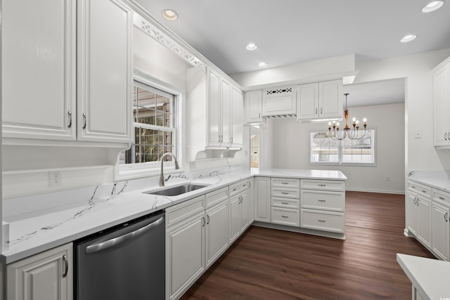 kitchen featuring stainless steel dishwasher, a sink, and white cabinets