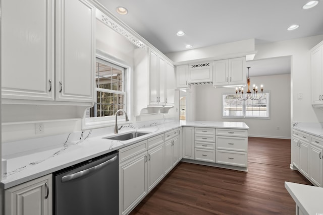 kitchen with plenty of natural light, stainless steel dishwasher, a sink, and white cabinetry