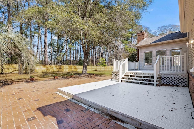 wooden deck featuring a patio area and a fenced backyard