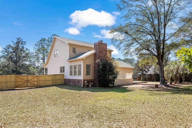 exterior space with crawl space, a chimney, fence, and a lawn