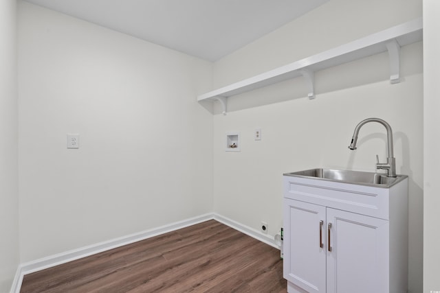 washroom with a sink, dark wood finished floors, baseboards, washer hookup, and electric dryer hookup