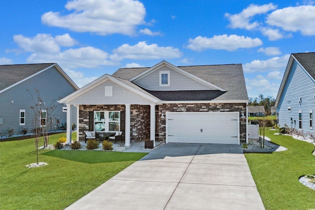 view of front of home featuring an attached garage, a shingled roof, stone siding, driveway, and a front lawn