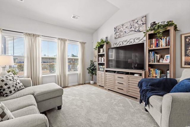 living area with lofted ceiling, light carpet, and visible vents