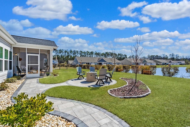 view of yard featuring a patio area, a residential view, a sunroom, and fence