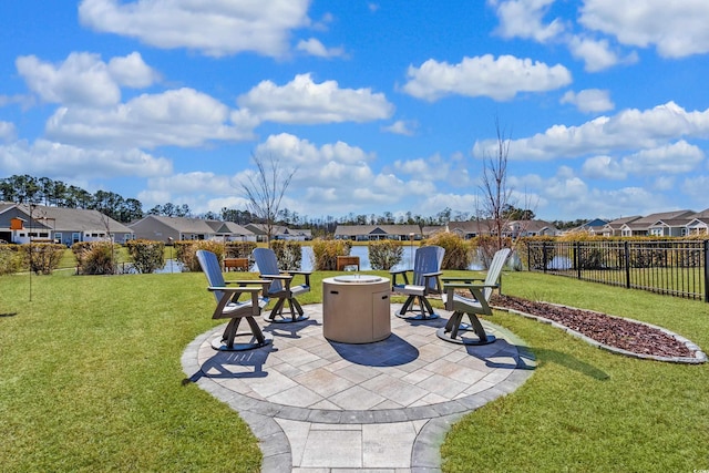 view of patio with a residential view, fence, and a fire pit