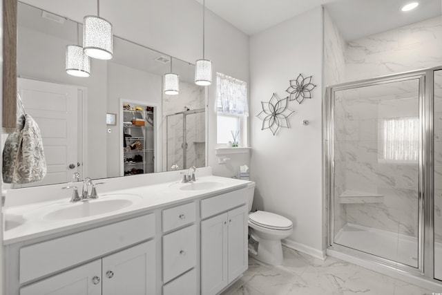 full bathroom featuring marble finish floor, a sink, toilet, and a shower stall