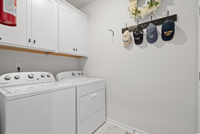 clothes washing area featuring cabinet space, baseboards, marble finish floor, and independent washer and dryer