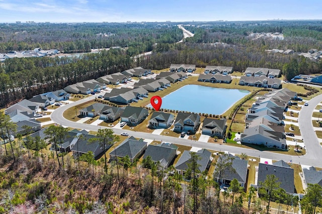 birds eye view of property featuring a forest view and a residential view