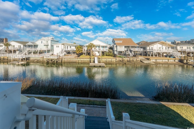 water view with a dock and a residential view